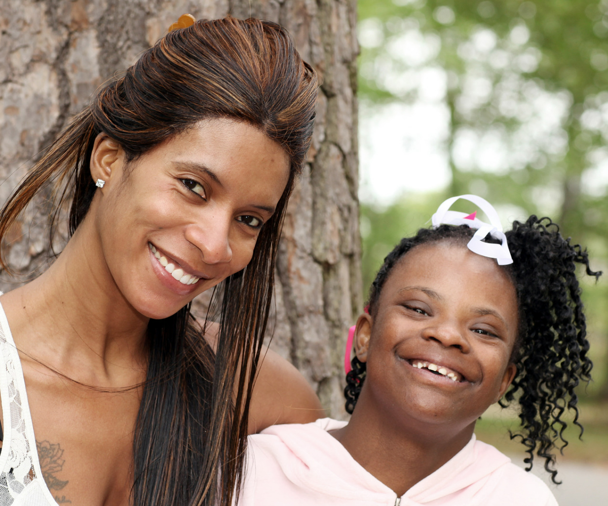 A woman and a girl smiling for the camera