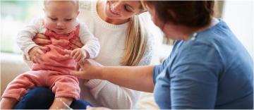 A woman holding a baby