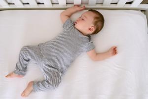 A baby sleeping in a crib