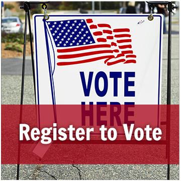 vote here sign with an american flag on it