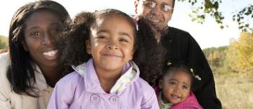 A family smiling into the camera